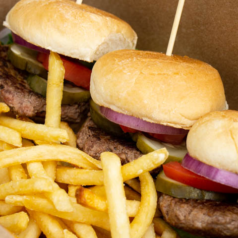 A juicy BAR HWRD burger with fries.